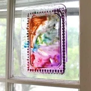 recycled lid suncatcher rainbow crafts - crafts for kids- kid crafts - acraftylife.com #preschool #kidscraft #craftsforkids 