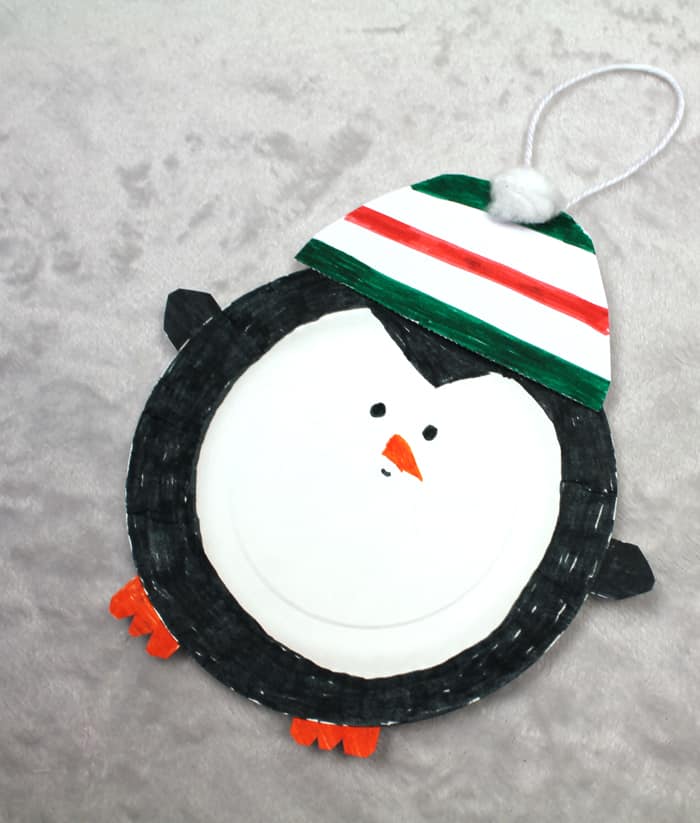 Make a cute penguin paper plate christmas ornament. This easy craft is great for kids.