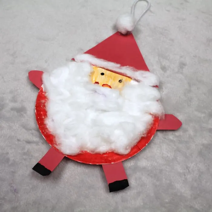 Make a paper plate Santa ornament Christmas craft.