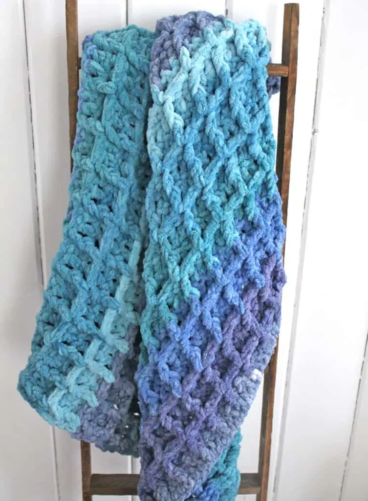 Try this easy super bulky yarn crocheted blanket pattern.