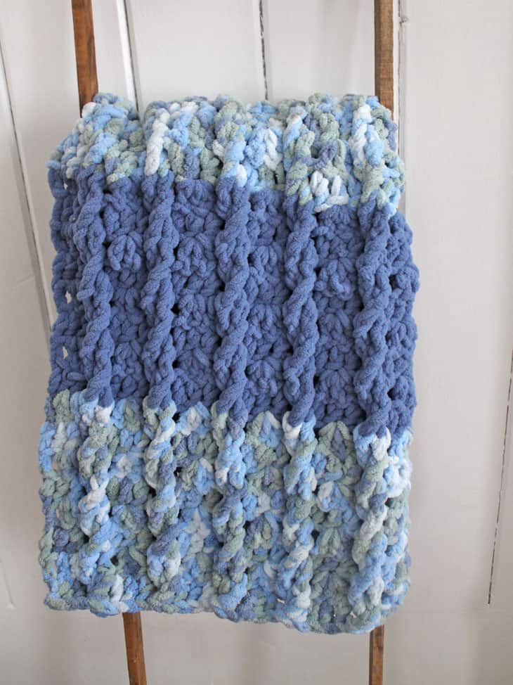 Try this chunky crocheting blanket pattern. There is a free PDF available.