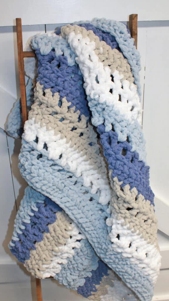 Try this free crochet blanket pattern using Bernat Blanket Yarn.  There is a free PDF available.