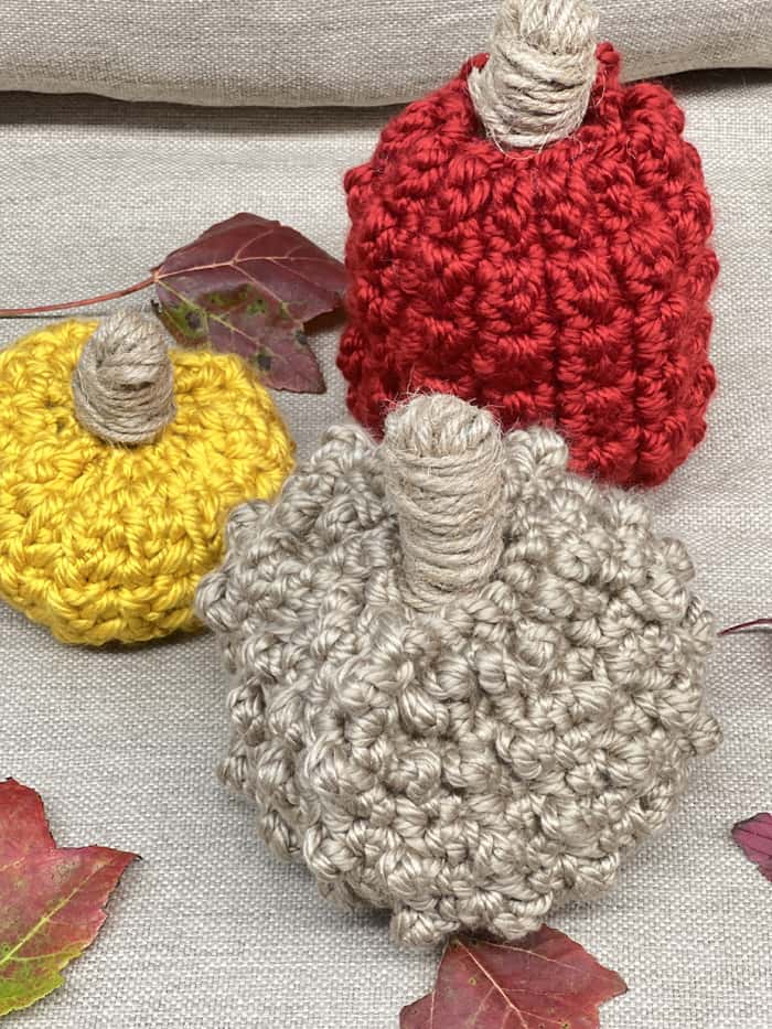 Make these 3 bulky yarn pumpkins. There are 3 different textures and sizes to choose from in this free pumpkin pattern.
